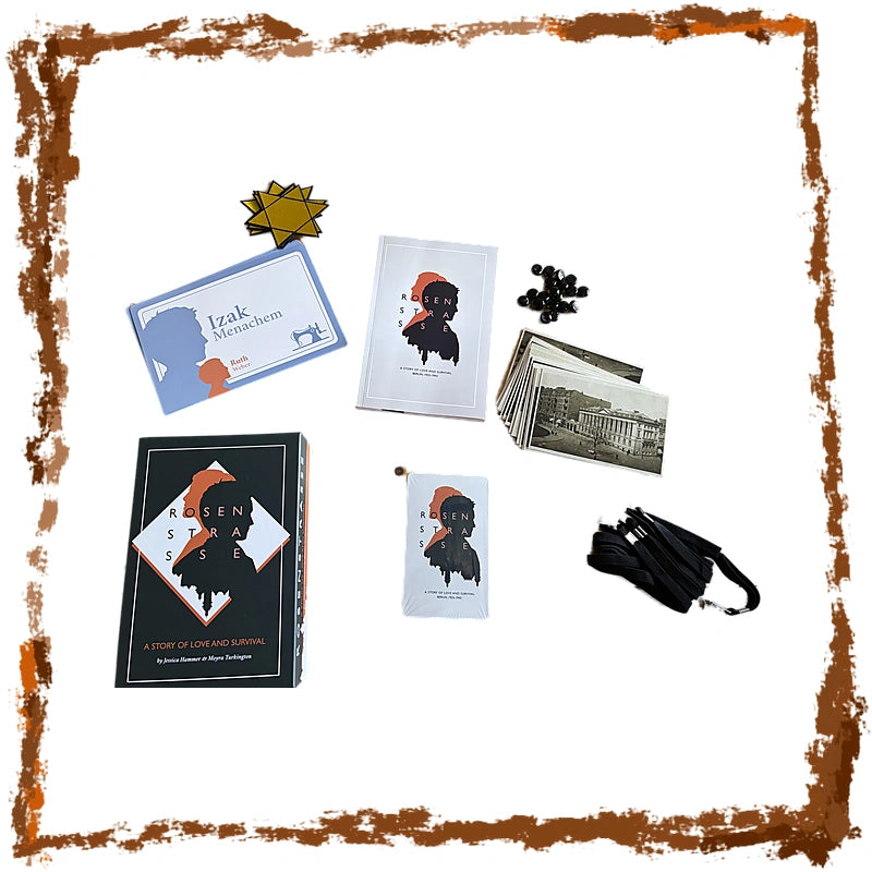A board game set laid out on a white background with a distressed brown border. The set includes a black box, cards, a blue instruction card, a gold star-shaped token, black game pieces, a folded black umbrella, and printed artwork featuring a stylized portrait.