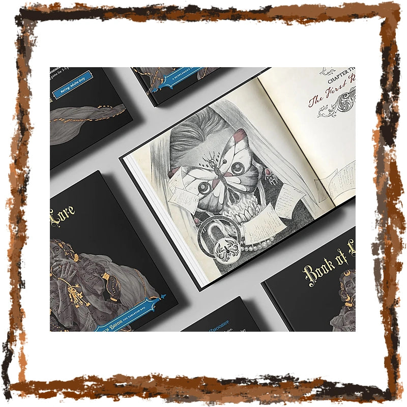 A styled flat-lay of a gothic art book and matching printed cards or booklets arranged on a light gray surface. The open book shows a detailed black-and-white illustration of a skull with a butterfly over its eyes, and the surrounding items feature dark covers with gold gothic lettering and gray artwork.