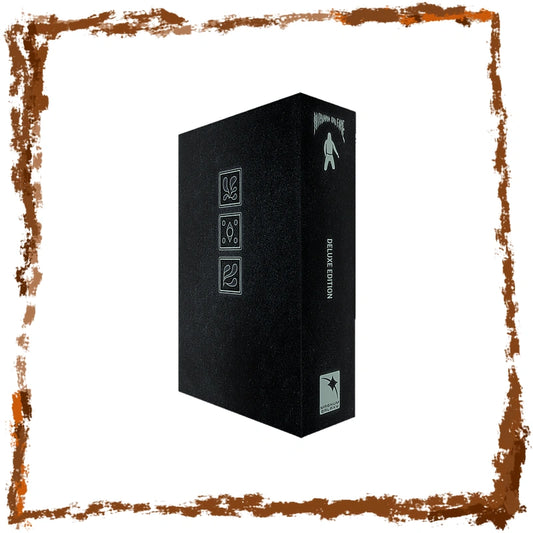A tall black rectangular box with silver-gray printed icons and vertical text reading 'Deluxe EDITION' on the spine, shown on a white background with a distressed brown border around the edges.